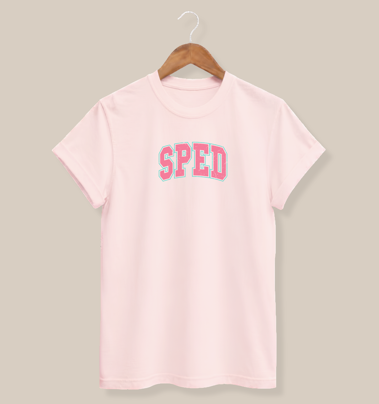 Bella + Canvas 3001 t-shirt in Soft Pink featuring a distressed varsity-style "SPED" graphic in pink with a mint green outline. A fun graphic tee celebrating special education, perfect for school spirit, classroom events, and everyday casual wear.