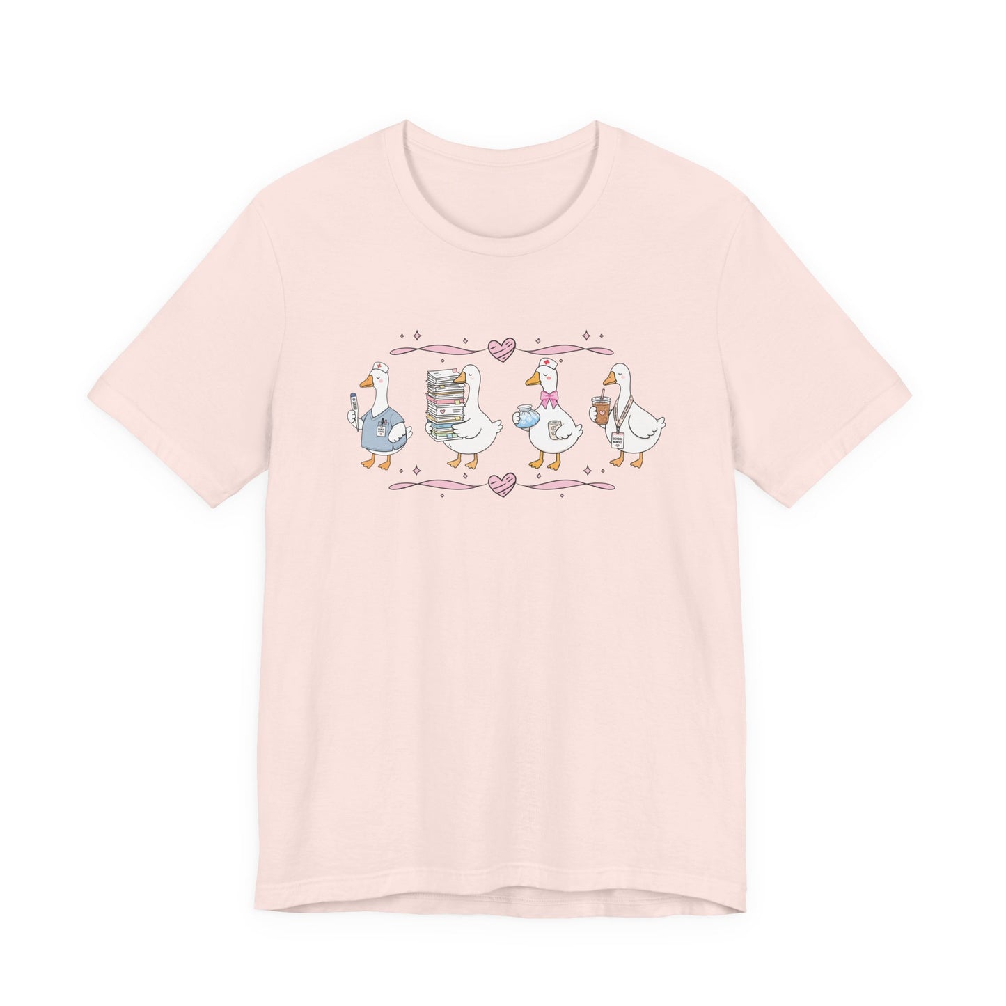 Bella + Canvas 3001 t-shirt in Soft Pink featuring a coquette school nurse goose design. Four white geese display nurse-themed accessories including scrubs, a thermometer, medical supplies, paperwork, iced coffee, and a school nurse badge. Pink hearts and ribbon accents create a playful aesthetic, making this cute school nurse shirt perfect for school nurses, healthcare workers, nurse appreciation gifts, medical staff, and back-to-school outfits.
