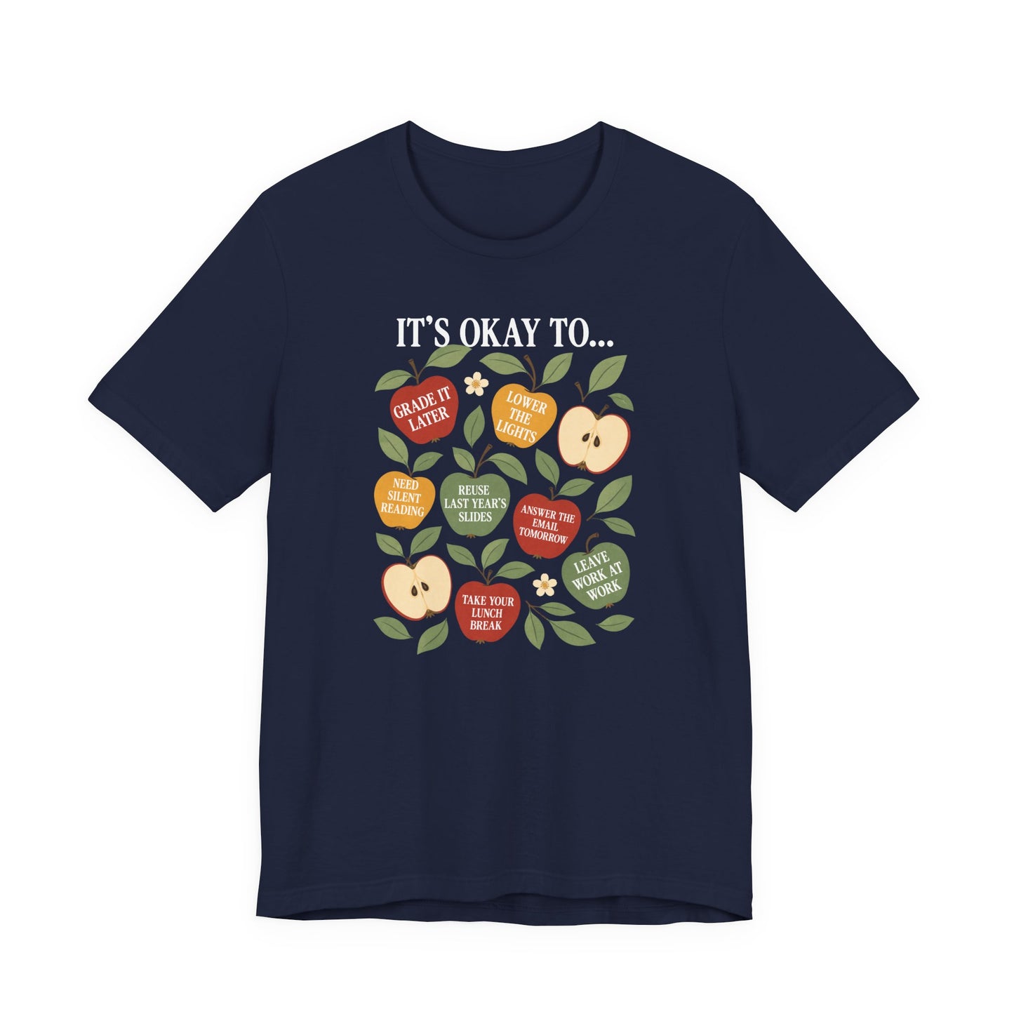 Bella + Canvas 3001 t-shirt in navy displayed on a white background featuring colorful apple graphics with teacher self care sayings including “Grade It Later,” “Take Your Lunch Break,” and “Answer the Email Tomorrow.”