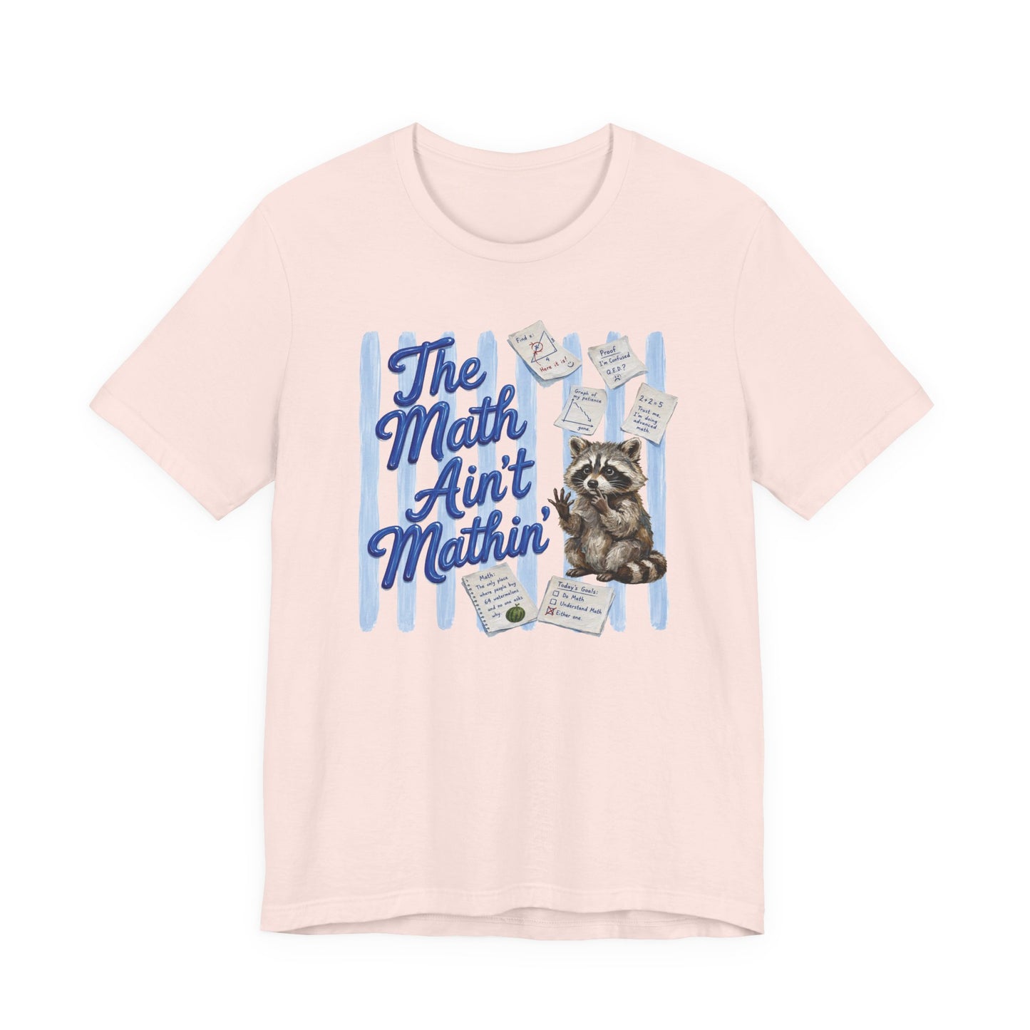 Bella + Canvas 3001 t-shirt in soft pink featuring the phrase “The Math Ain’t Mathin’” in blue script lettering with a puzzled raccoon surrounded by math equations, geometry notes, classroom papers, and problem-solving worksheets. Funny math teacher shirt for algebra teachers, geometry teachers, middle school educators, high school math teachers, tutors, and STEM professionals who enjoy classroom humor.