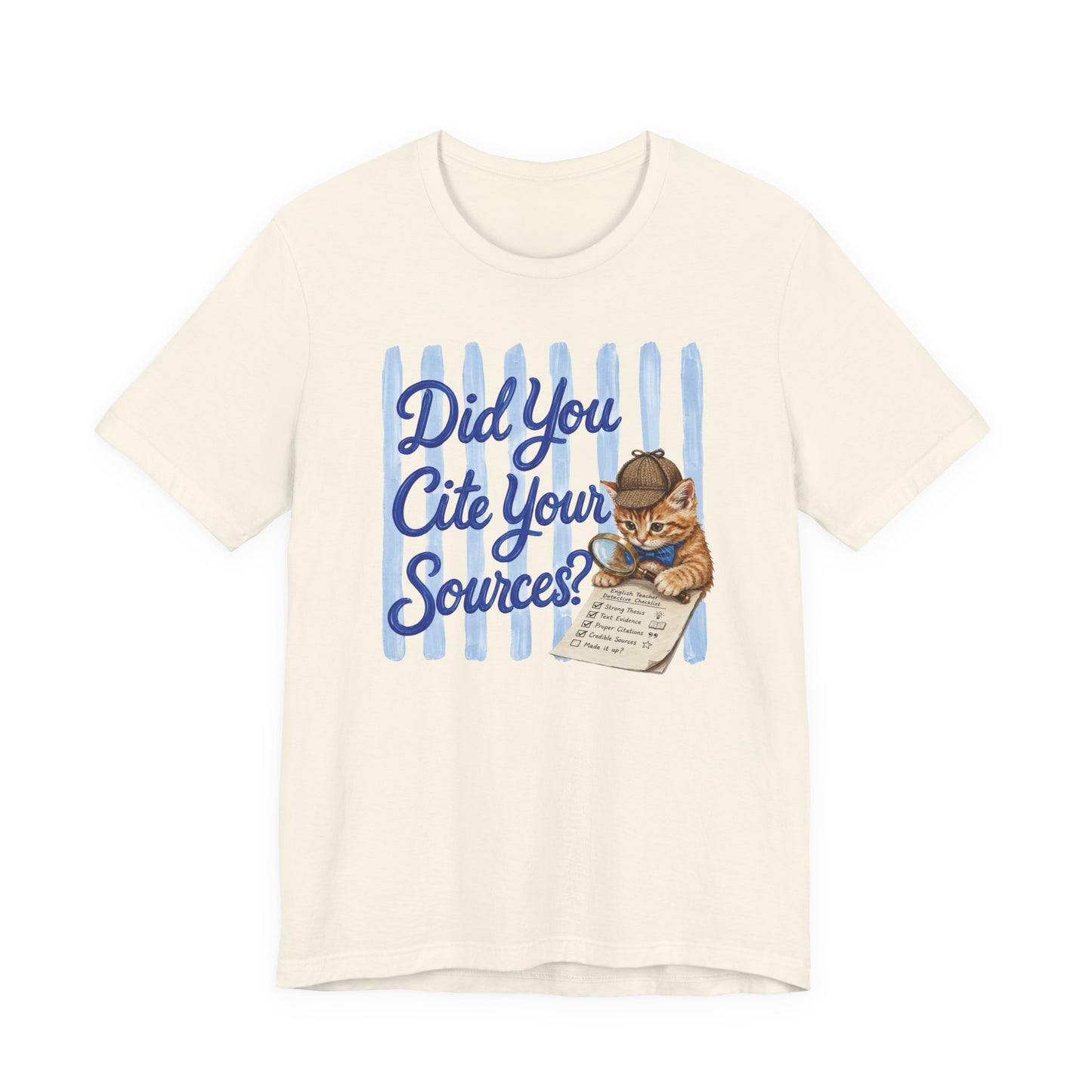 Bella + Canvas 3001 t-shirt in natural featuring the phrase “Did You Cite Your Sources?” in blue script with a detective kitten holding a magnifying glass and reviewing a paper checklist. Funny English teacher shirt for language arts teachers, librarians, reading specialists, book lovers, and educators who value research and proper citations.