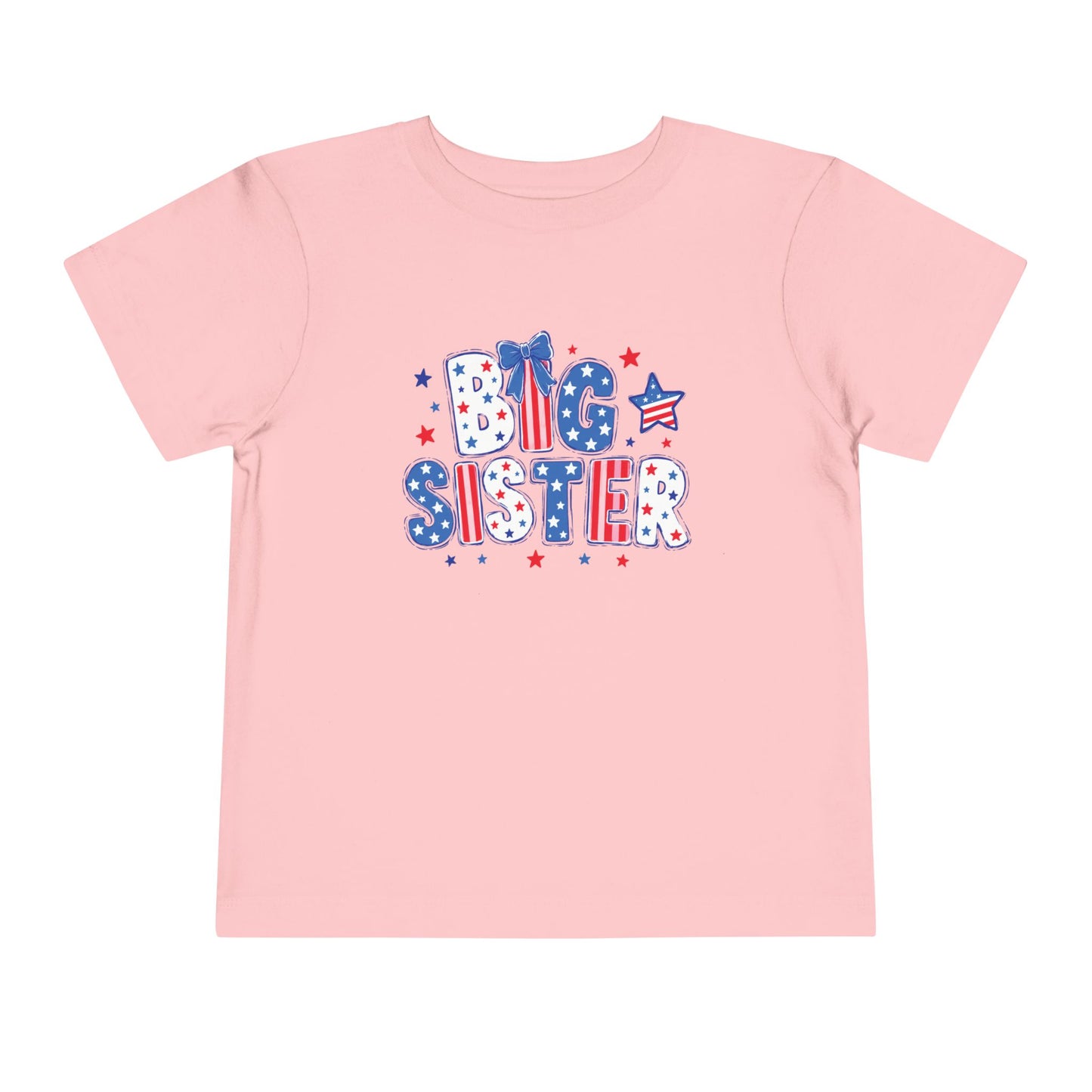 Light pink Bella + Canvas toddler t-shirt featuring a patriotic “Big Sister” graphic in red, white, and blue with stars, striped lettering, and bow detail for Fourth of July sibling outfits.