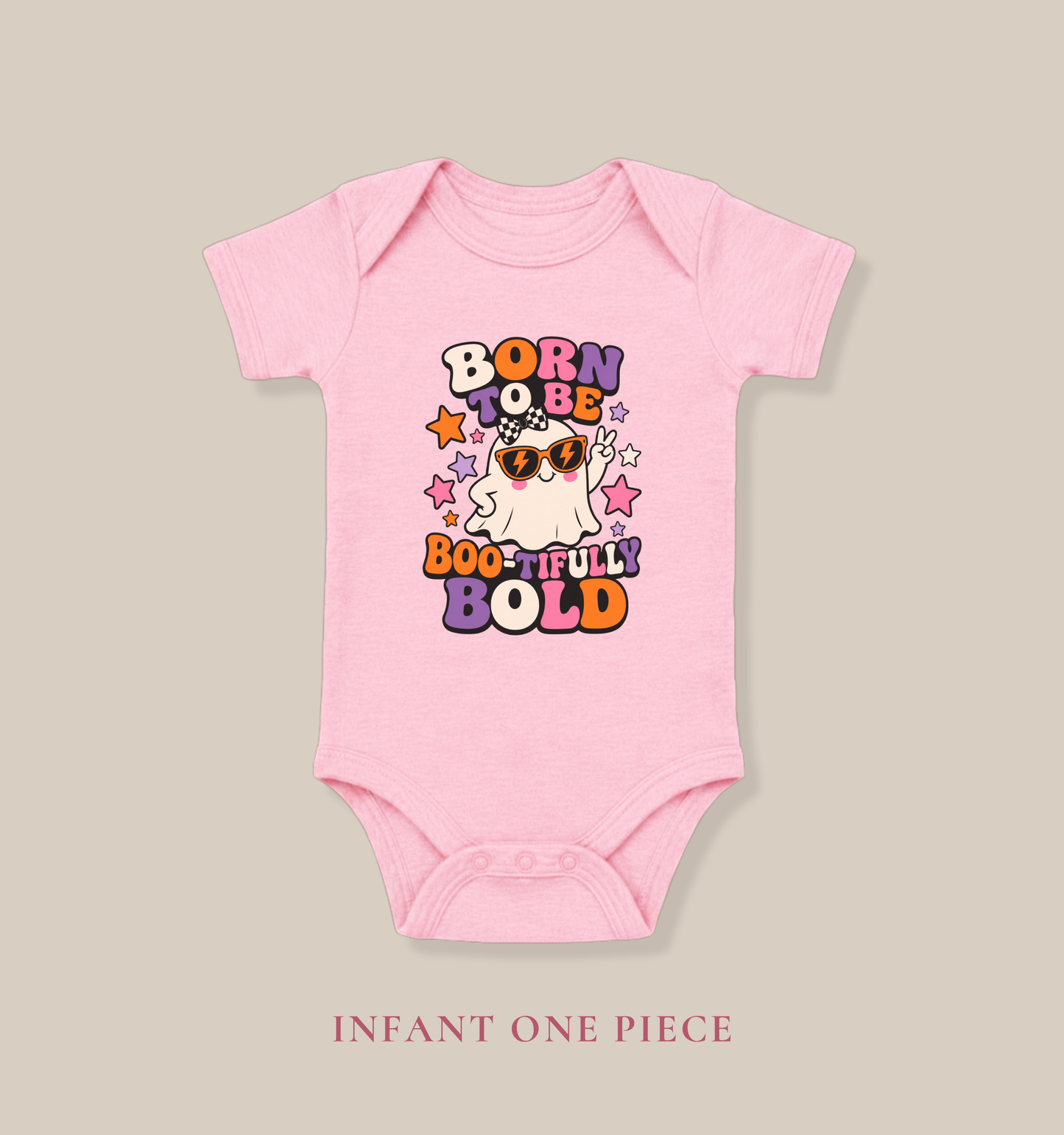 Pink baby one piece featuring a playful ghost wearing orange sunglasses, colorful stars, and the phrase “Born to Be Boo-tifully Bold.”