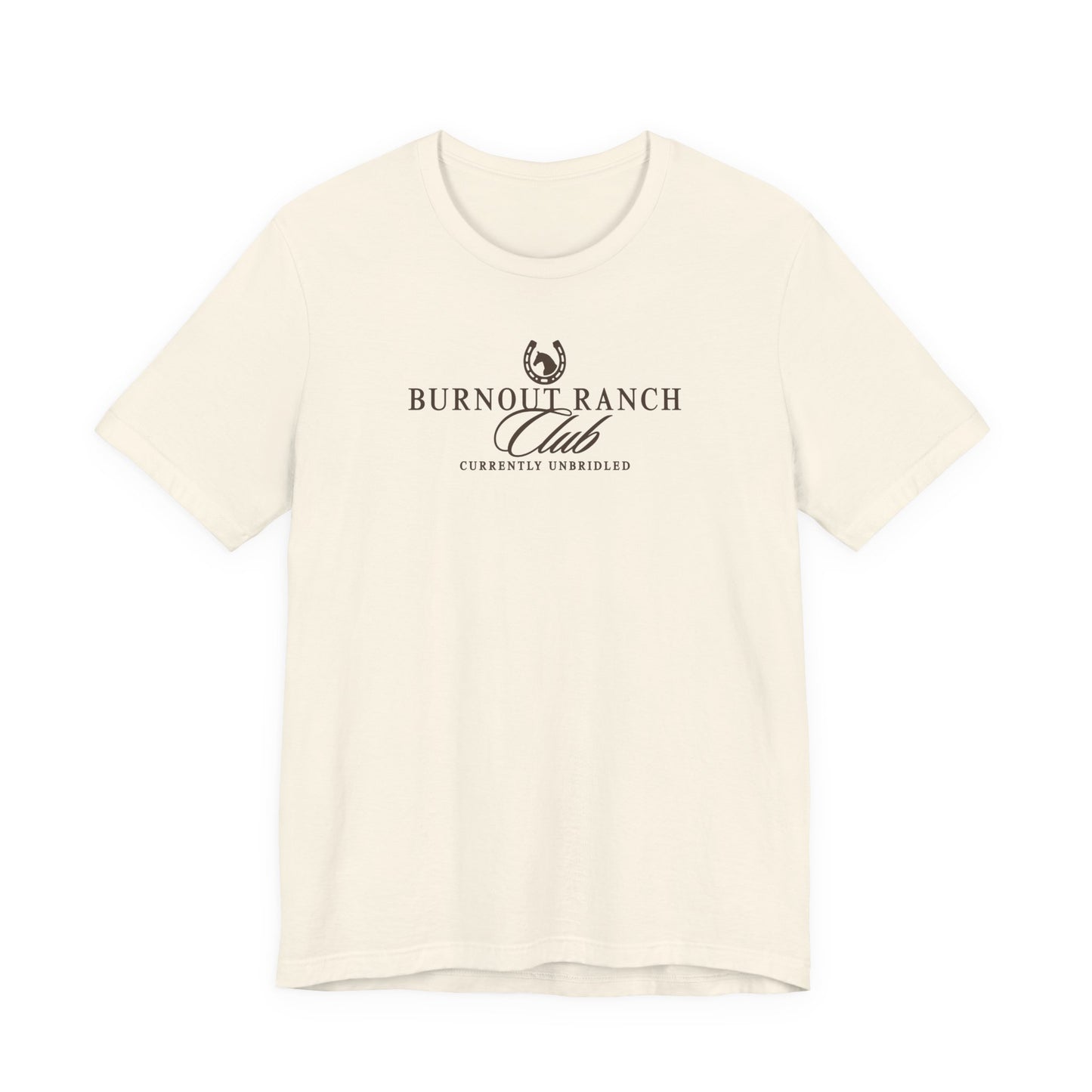 Natural Bella + Canvas 3001 t-shirt featuring a western-inspired “Burnout Ranch Club” graphic with “Currently Unbridled” text in dark green lettering.
