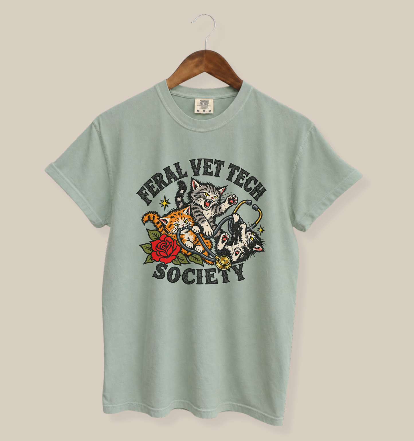 Bay vintage feel T-shirt with a Feral Vet Tech Society design showing three expressive cats wrapped around a stethoscope with red rose artwork.