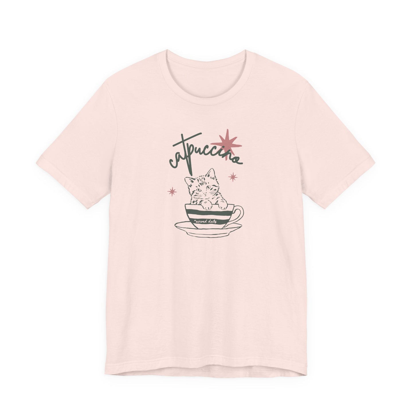 Soft pink Bella + Canvas 3001 t-shirt featuring a minimalist “Catuccine” cat coffee graphic with a kitten sitting inside a coffee cup and retro-inspired lettering.