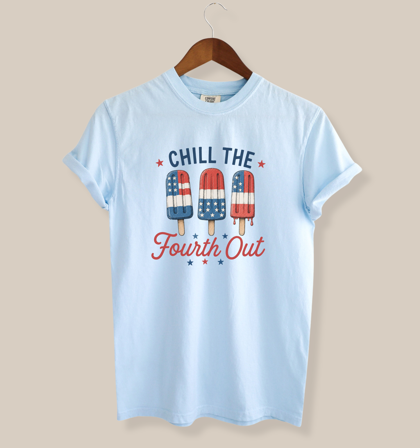 Adult Comfort Colors chambray blue t-shirt featuring a patriotic “Chill the Fourth Out” graphic with red, white, and blue popsicles decorated in American flag patterns and festive Fourth of July stars.