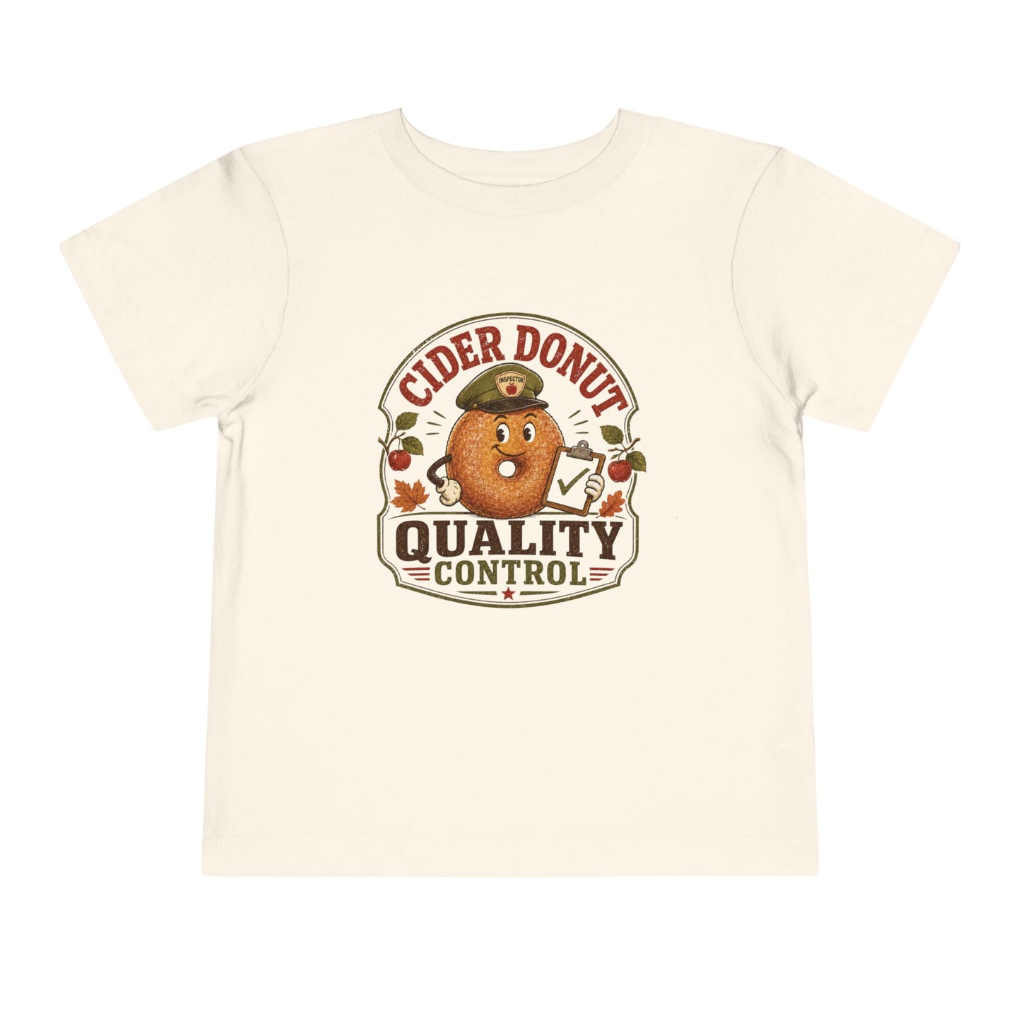 Natural color toddler T-shirt featuring a vintage cider donut inspector graphic with apples, autumn leaves, and the phrase “Cider Donut Quality Control.”