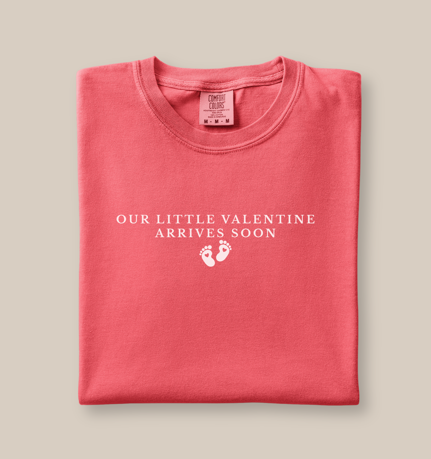 Folded pink shirt with text that says Our Little Valentine Arrives Soon