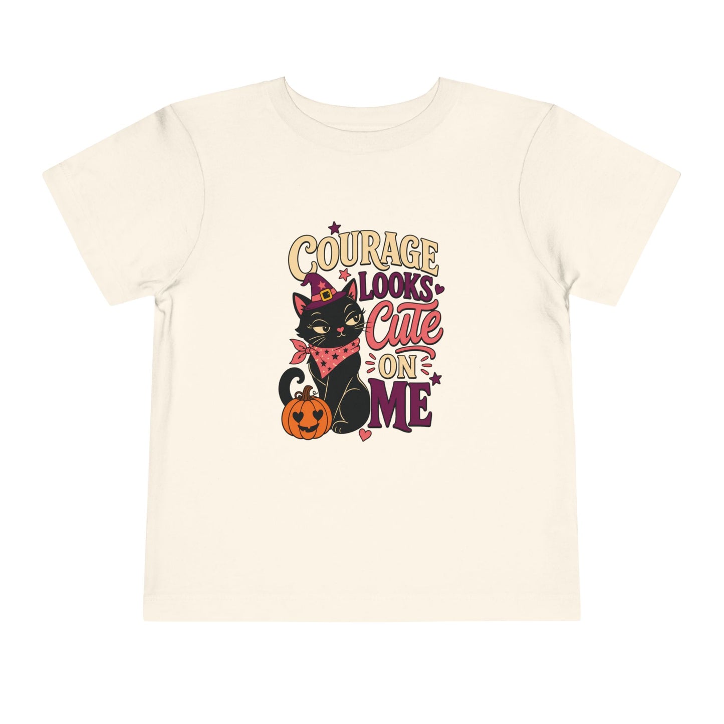 Natural toddler T-shirt featuring a black cat in a witch hat, a heart-eyed pumpkin, stars, and an encouraging courage-themed phrase.
