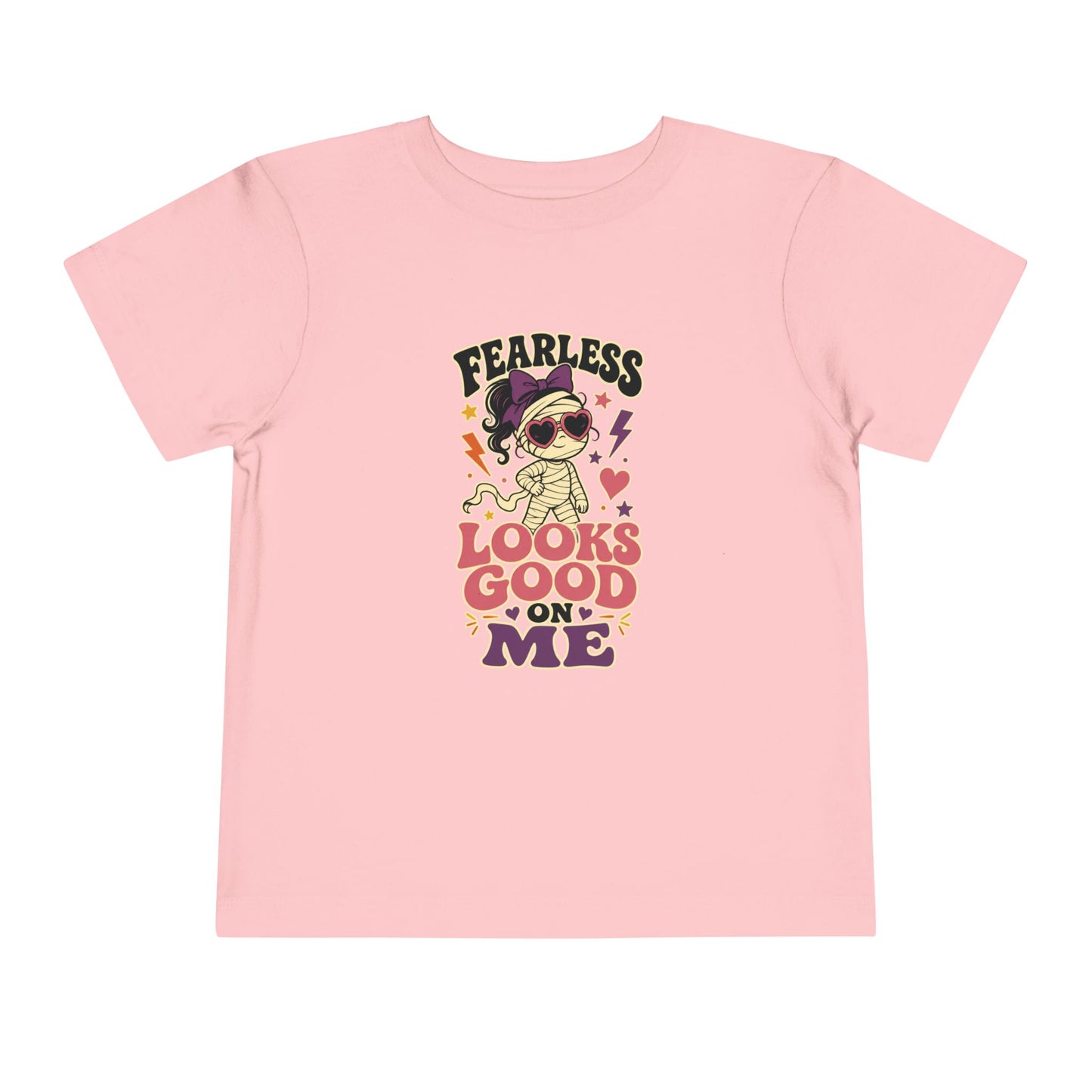 Pink toddler T-shirt featuring a stylish mummy in heart-shaped sunglasses, colorful lightning bolts, stars, and the phrase “Fearless Looks Good on Me.”