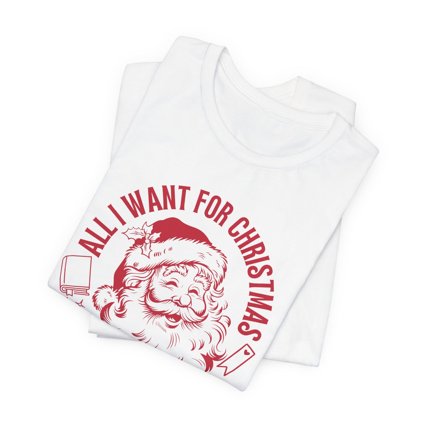 Folded white T-shirt with red Santa graphic and the phrase “All I Want for Christmas Is Silent Reading.”