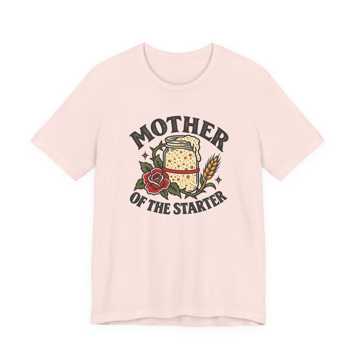 Soft pink classic fit tee displaying a Mother of the Starter design with a starter jar, floral accents, wheat, and vintage-style text.