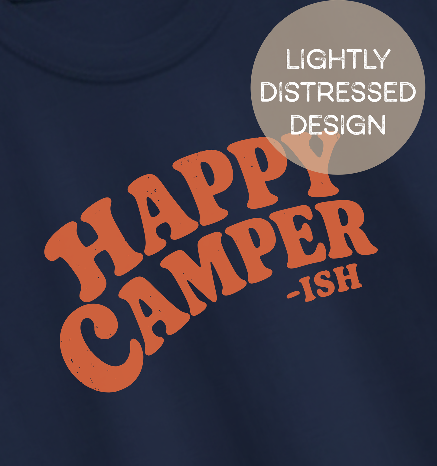Close-up of a navy adult T-shirt featuring lightly distressed orange retro lettering and the humorous phrase “Happy Camper-ish.”