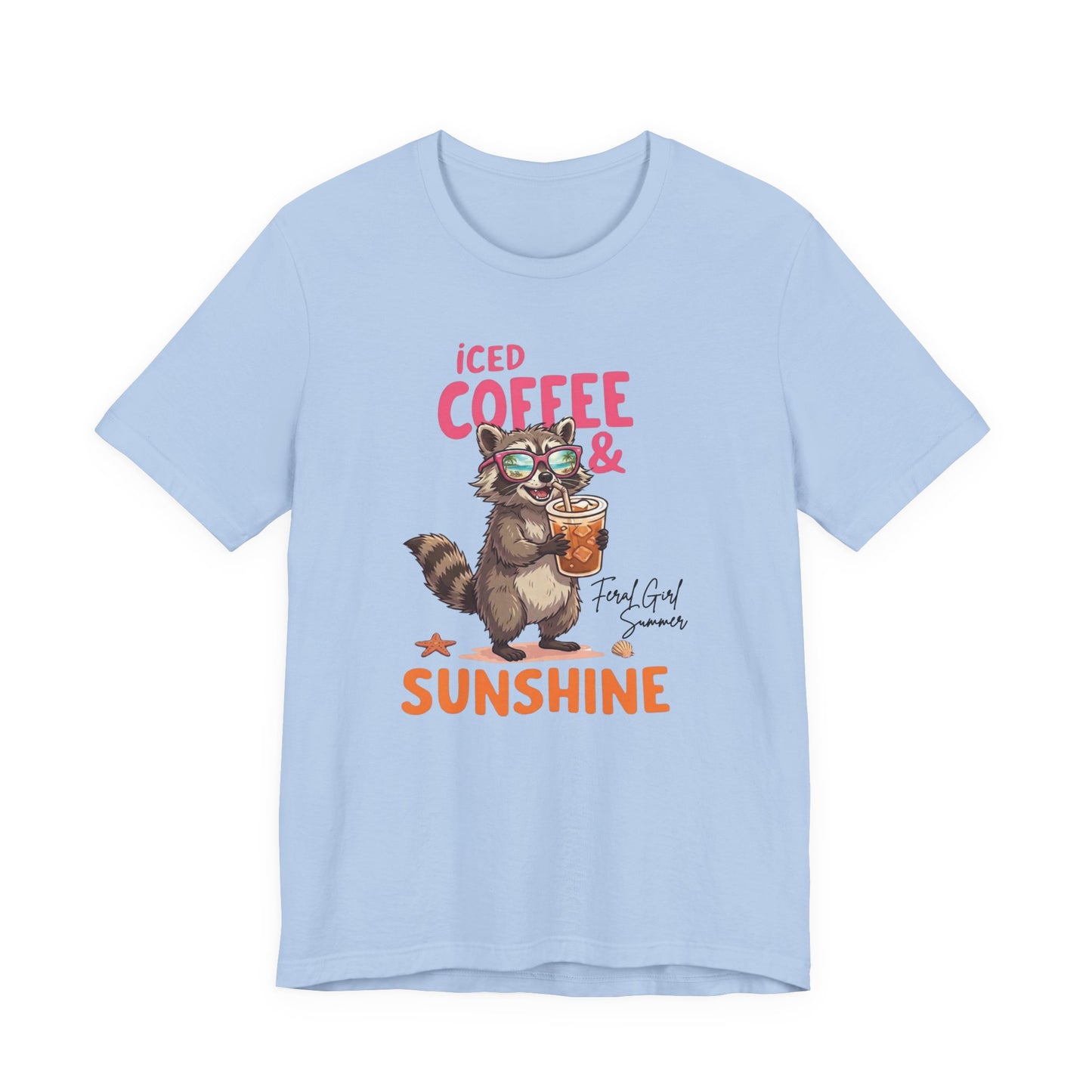 Bella + Canvas 3001 t-shirt in baby blue featuring a raccoon wearing sunglasses and holding an iced coffee with the phrase “Iced Coffee & Sunshine” in colorful summer-inspired lettering.