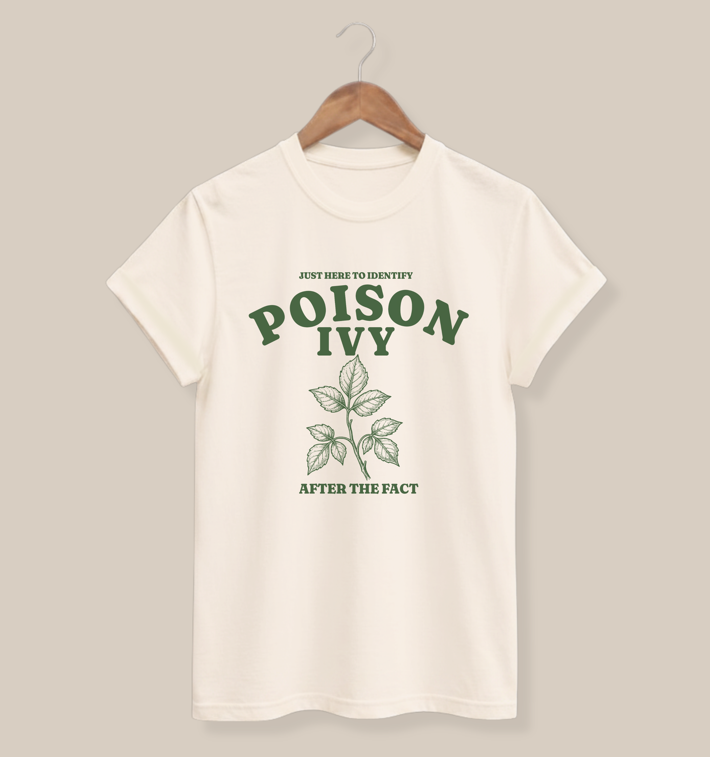 Natural adult T-shirt featuring a vintage green poison ivy illustration and the phrase “Just Here to Identify Poison Ivy After the Fact.”