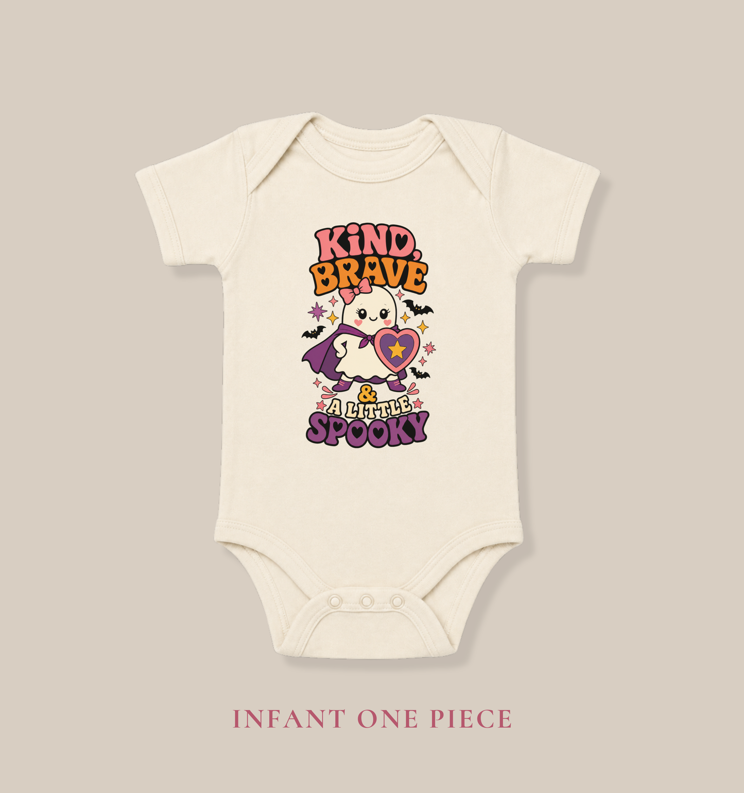 Natural color baby one piece featuring a brave ghost in a purple cape with a heart shield, bats, stars, and empowering Halloween lettering.