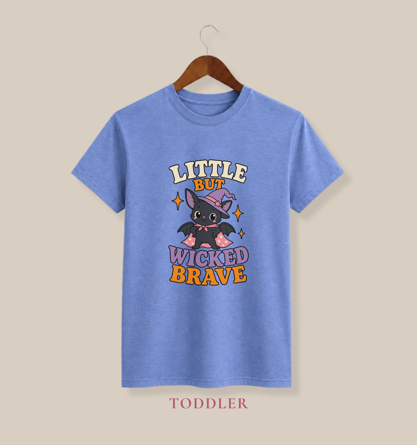 Heather Columbia blue toddler T-shirt featuring a cute bat dressed as a witch, colorful stars, and the phrase “Little but Wicked Brave.”