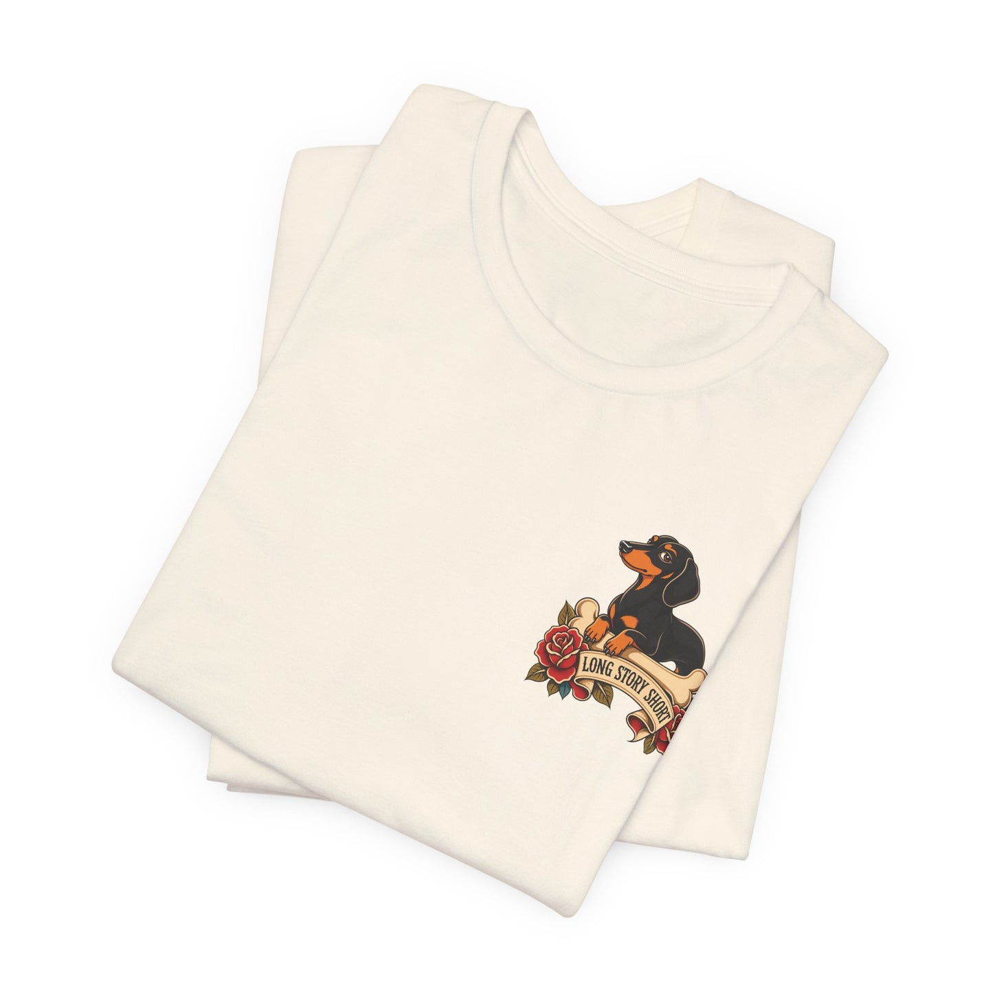 Natural adult T-shirt featuring a small dachshund resting on a bone above red roses and a banner reading “Long Story Short.”