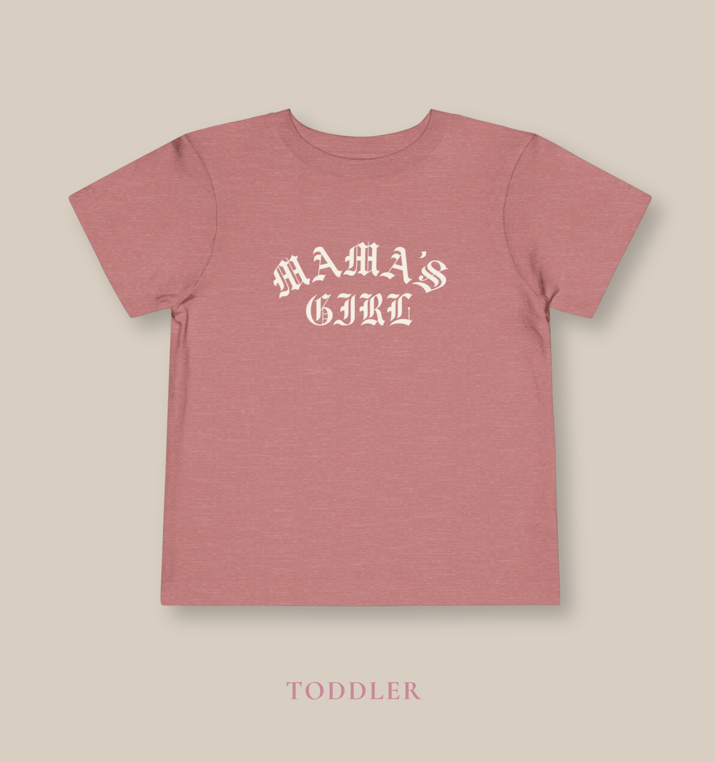 Heather mauve Bella + Canvas toddler tee featuring a cream “Mama’s Girl” gothic-style graphic for trendy toddler outfits, neutral girl fashion, and modern matching mommy-and-me apparel.
