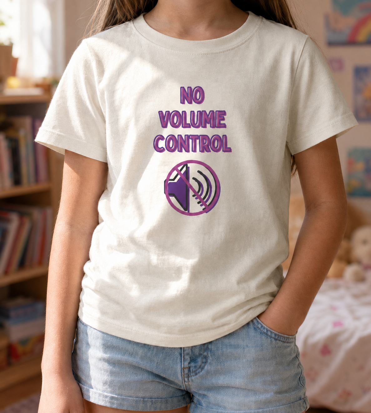 Girl wearing a natural youth T-shirt featuring the phrase “No Volume Control” with a purple and pink crossed-out speaker graphic.