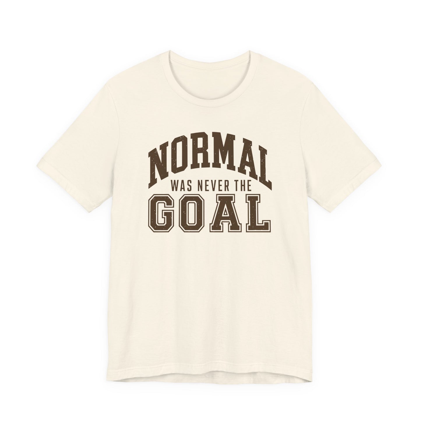 Natural adult T-shirt featuring distressed brown varsity lettering and the humorous phrase “Normal Was Never the Goal.”