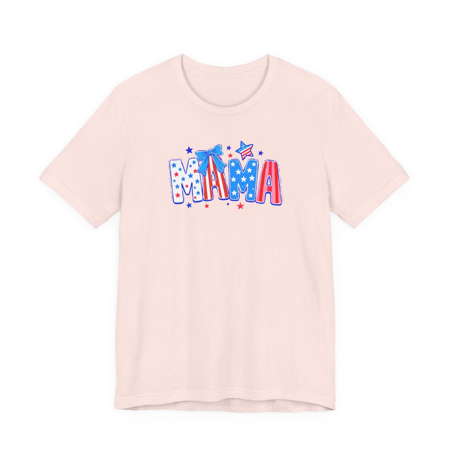 Adult Bella + Canvas light pink t-shirt featuring a playful patriotic “MAMA” graphic with red, white, and blue stars, striped lettering, and a blue bow accent in a cute Fourth of July inspired design.