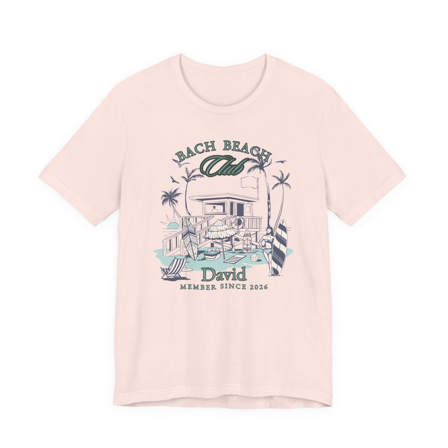 Personalized Bella + Canvas 3001 t-shirt in soft pink featuring a retro beach bachelor party design with palm trees, surfboards, beach house artwork, custom name text, and “Bach Beach Club Member Since 2026” wording in coastal green and blue lettering.