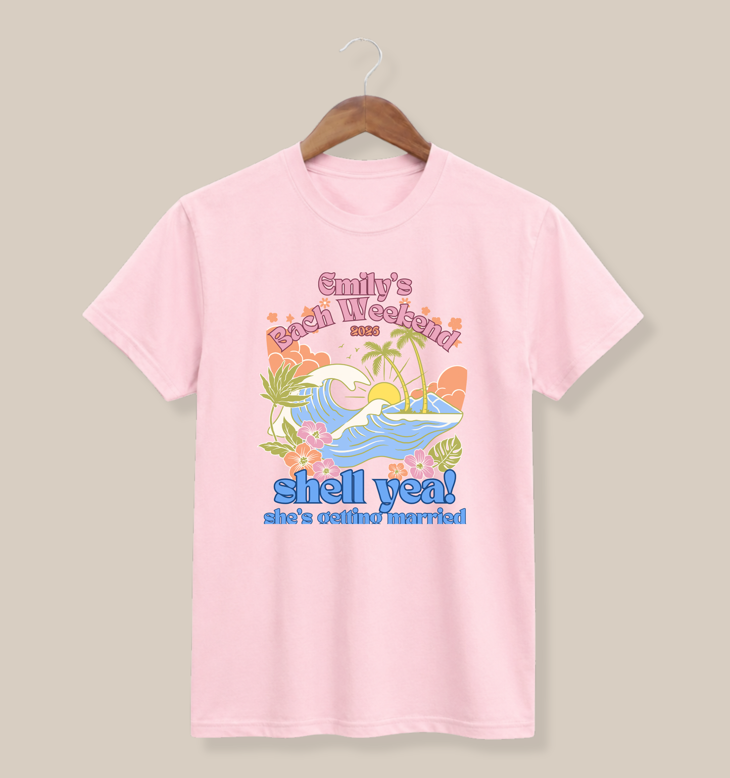 Soft pink Bella + Canvas 3001 t-shirt featuring a personalized beach-themed bachelorette party design with tropical waves, palm trees, flowers, bride name, bach weekend text, and “Shell Yeah! She’s Getting Married” wording.