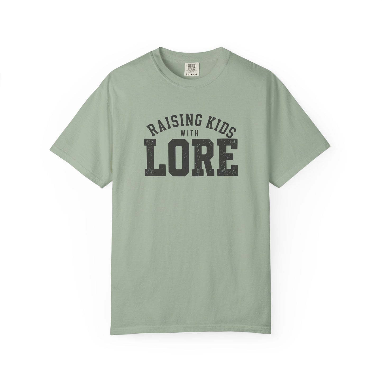 Bay green garment-dyed adult T-shirt featuring distressed varsity typography and the playful parenting phrase “Raising Kids With Lore.”