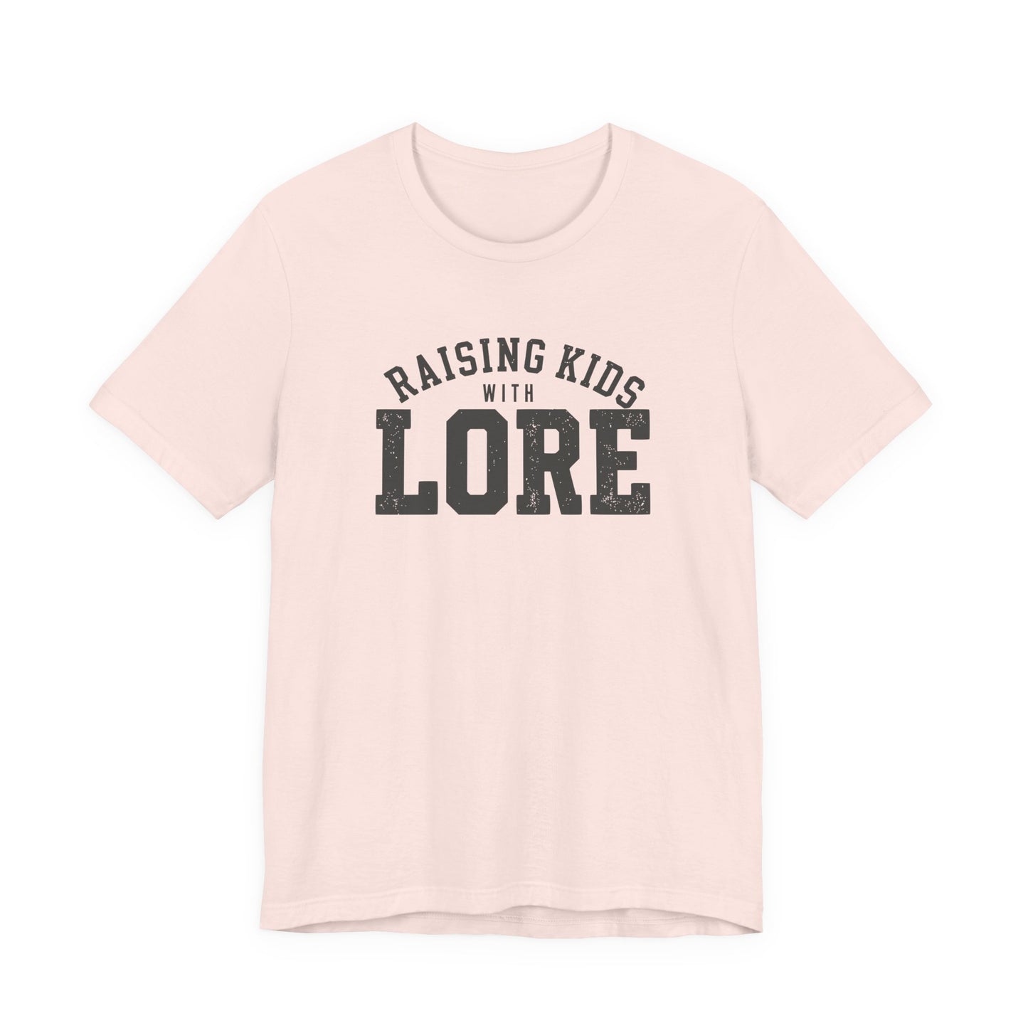 Soft pink adult shirt featuring a lightly distressed charcoal design and the humorous saying “Raising Kids With Lore.”