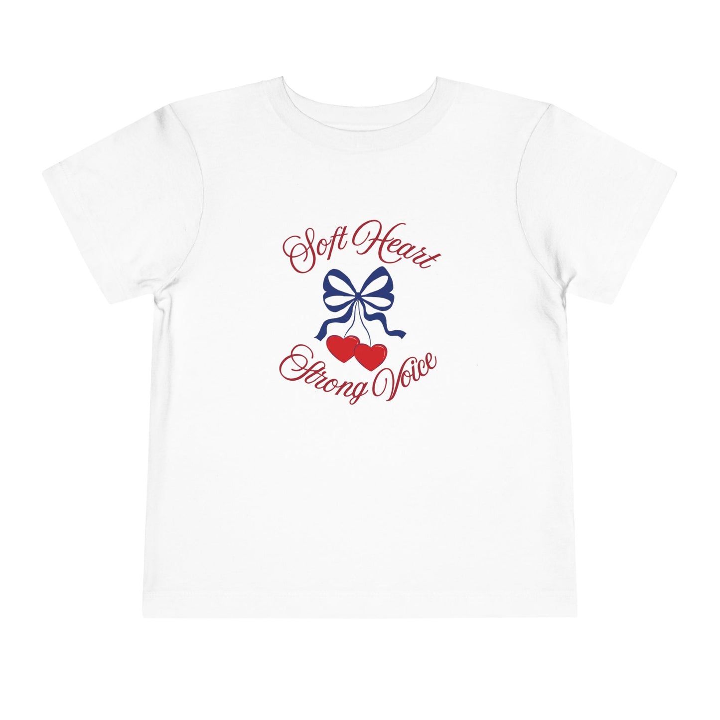 White color toddler T-shirt featuring a navy bow, red hearts, and the empowering phrase “Soft Heart Strong Voice.”