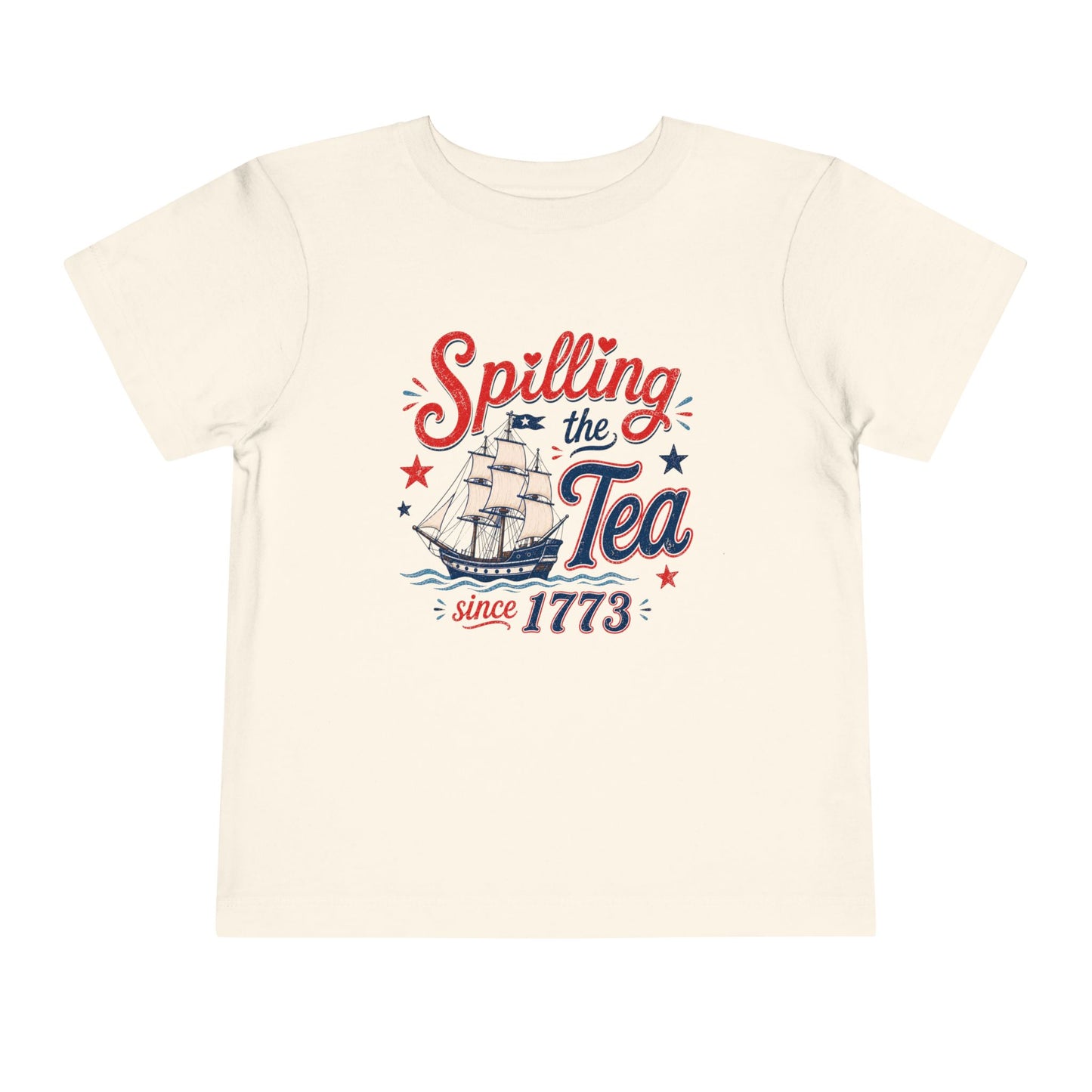 Toddler Bella + Canvas natural colored t-shirt featuring a vintage patriotic “Spilling the Tea Since 1773” design with a colonial ship, red and blue lettering, stars, and distressed Fourth of July graphics.