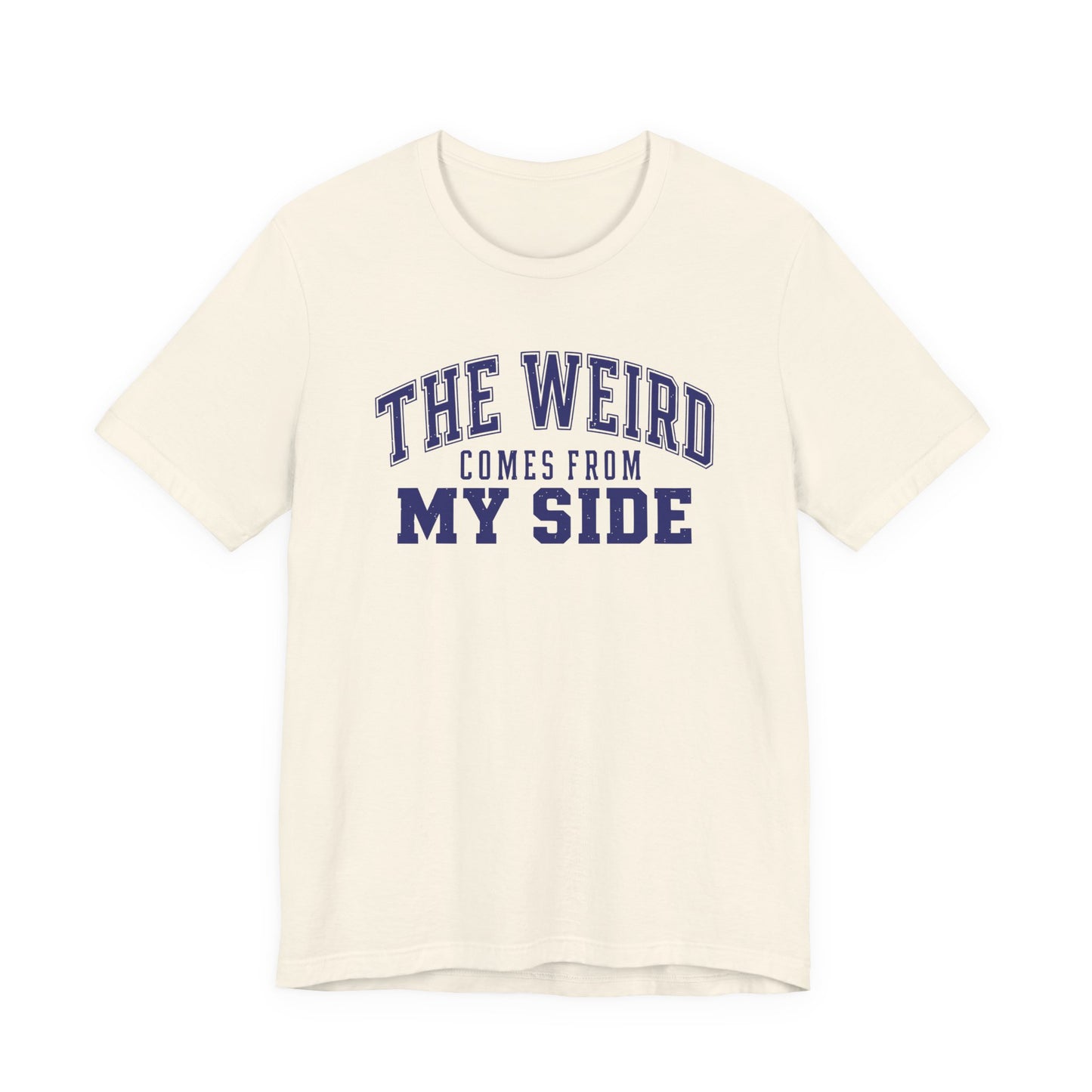 Natural adult T-shirt featuring a distressed blue varsity-style design with the humorous phrase “The Weird Comes From My Side.”