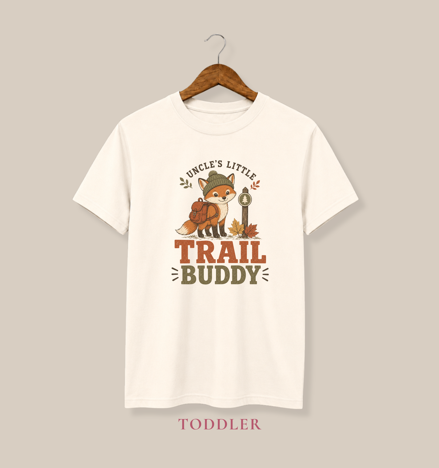 Natural toddler T-shirt featuring a backpack-wearing fox, autumn leaves, and the phrase “Uncle’s Little Trail Buddy.”