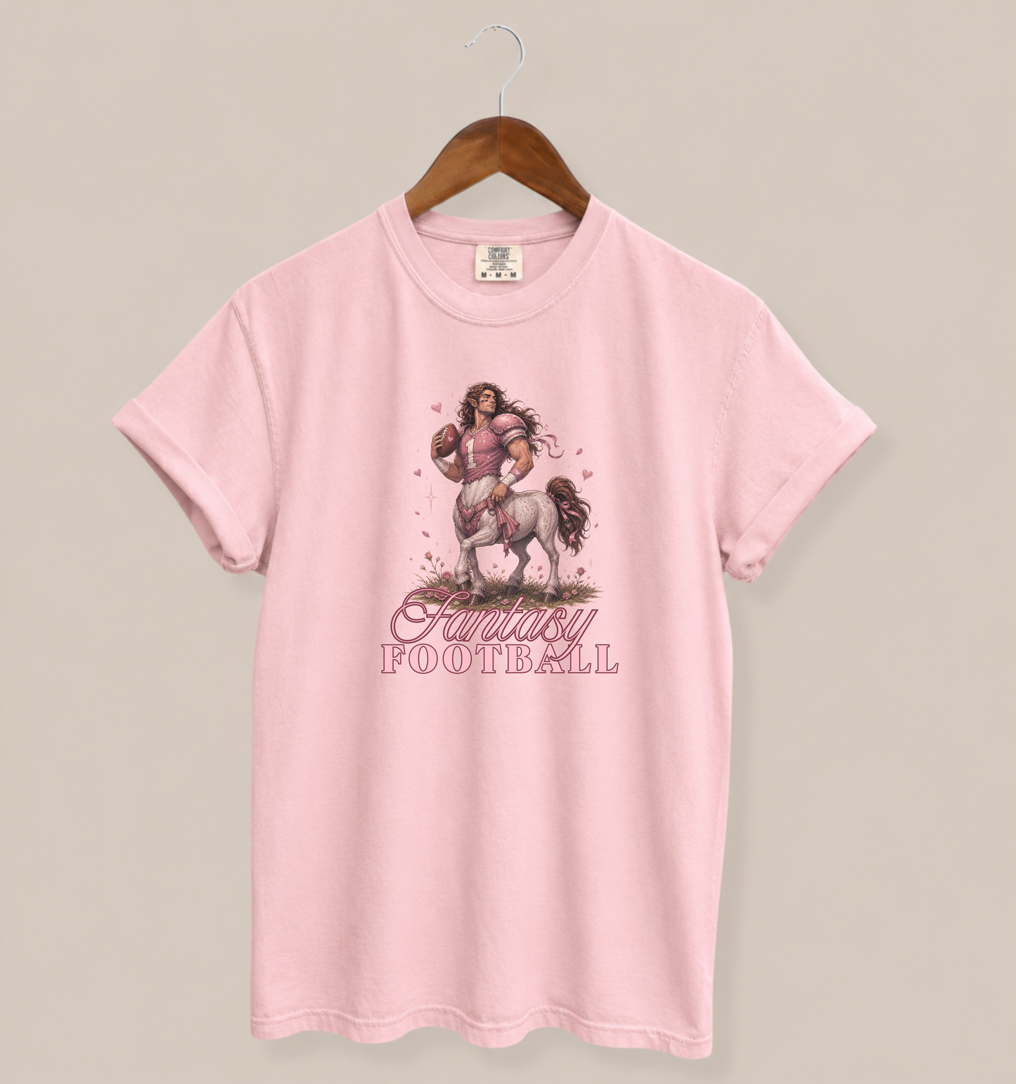 blossom pink graphic tee featuring a romantasy-inspired centaur football player with flowing hair and fantasy football text in a feminine fantasy sports design