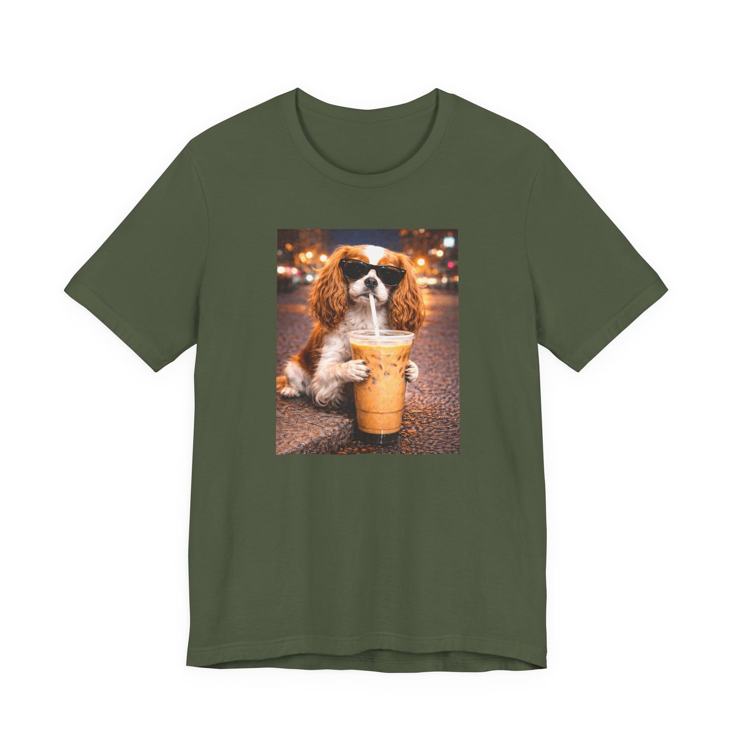 military green graphic t-shirt featuring a cavalier king charles spaniel in sunglasses holding an iced coffee on a city street background