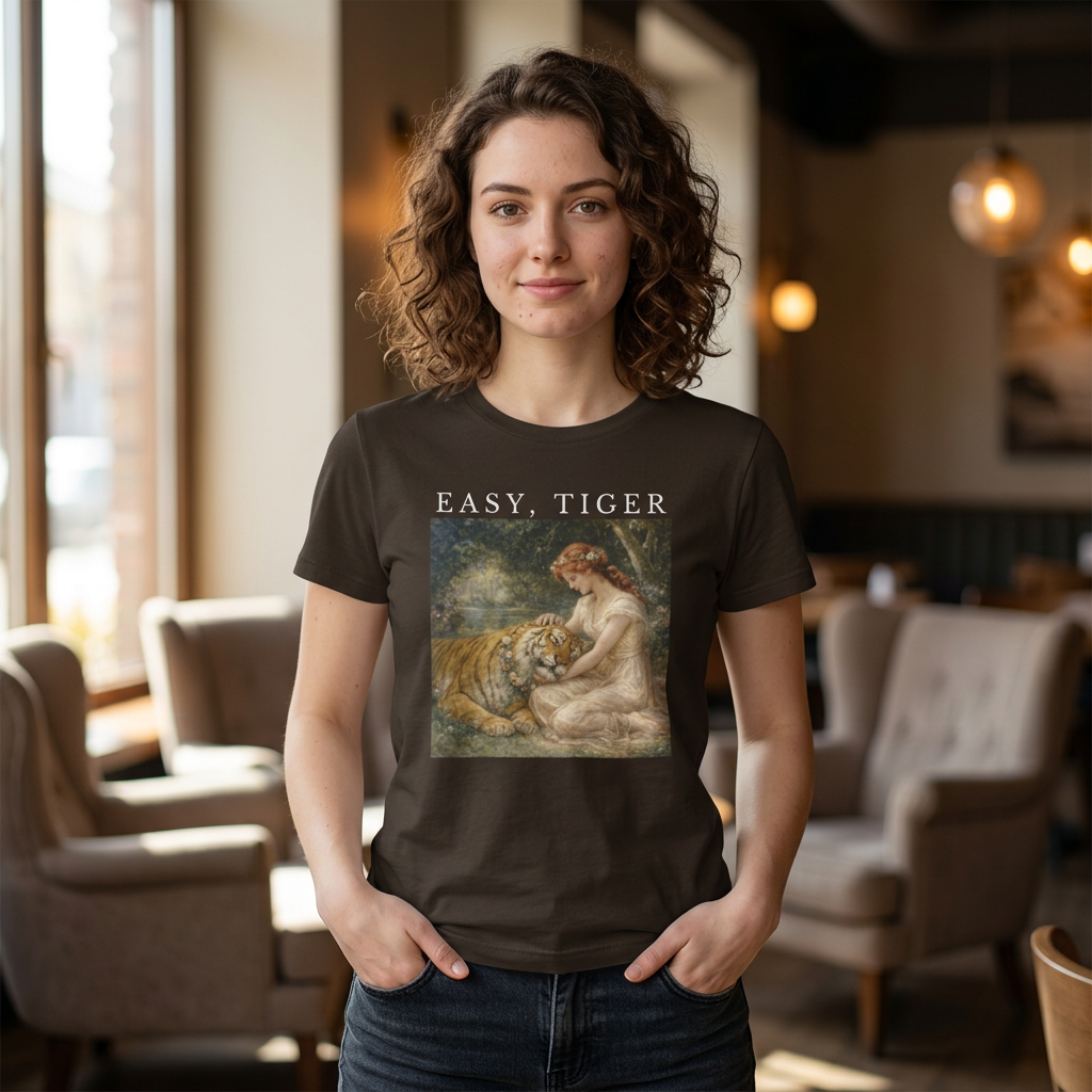 brown “Easy, Tiger” graphic tee on woman in casual indoor setting with vintage tiger illustration