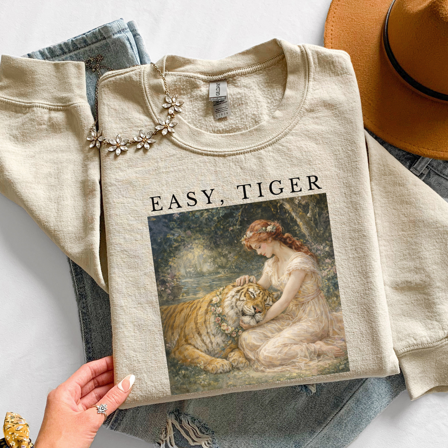 sand “Easy, Tiger” vintage tiger graphic sweatshirt styled in a neutral flat lay with denim jeans, accessories, and cozy aesthetic