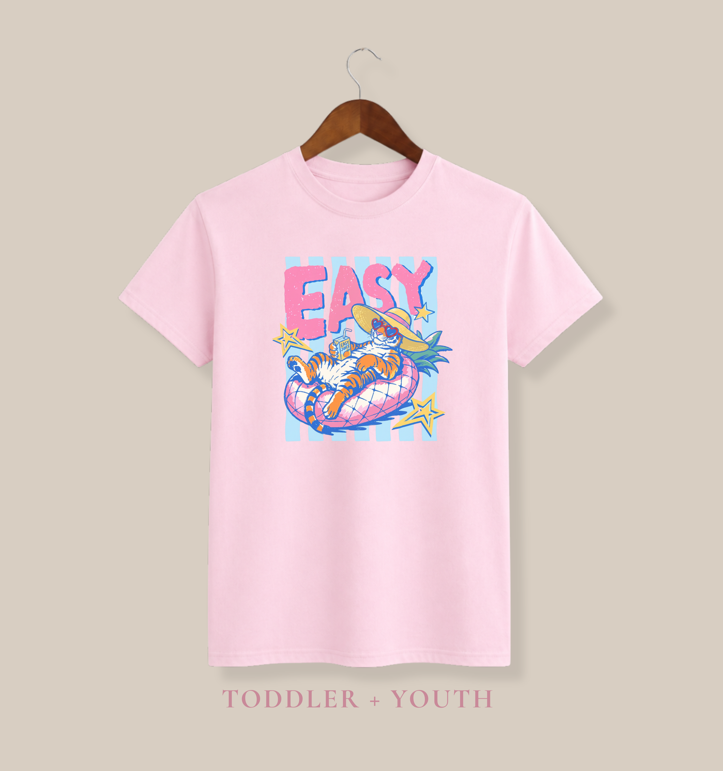 cute light pink toddler summer shirt with colorful easy tiger graphic showing lounging tiger wearing sunglasses and floppy hat in tropical pool floating