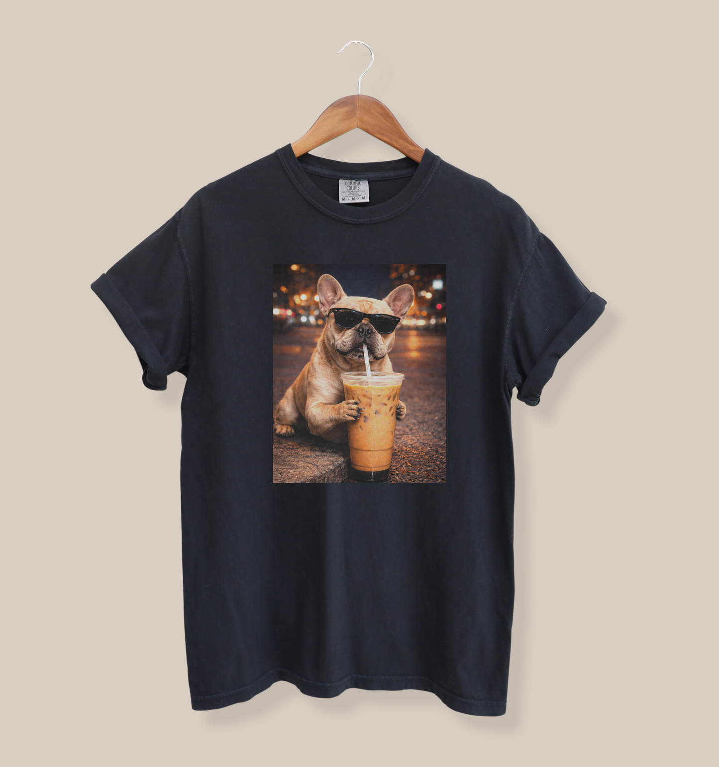 black graphic t-shirt featuring a french bulldog in sunglasses holding and drinking iced coffee at night city street